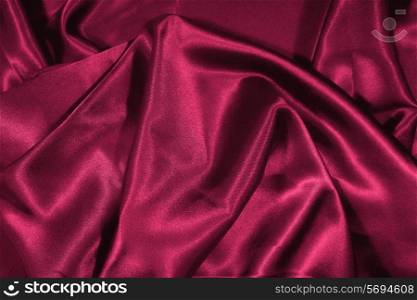 Texture of red satin silk close up