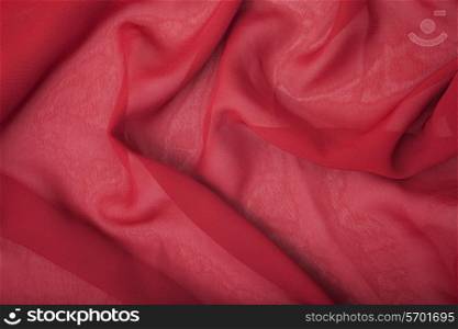 Texture of red satin silk close up