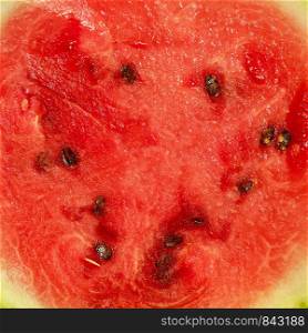 texture of ripe red watermelon with seeds, juicy flesh, full frame