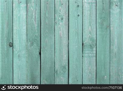 Texture of rough green painted wooden fence background