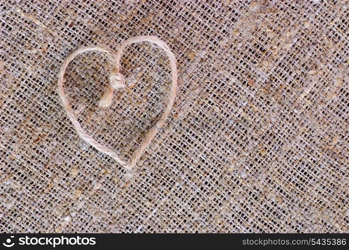 Texture of sackcloth close up and heart shape from rope. Antiquity environment