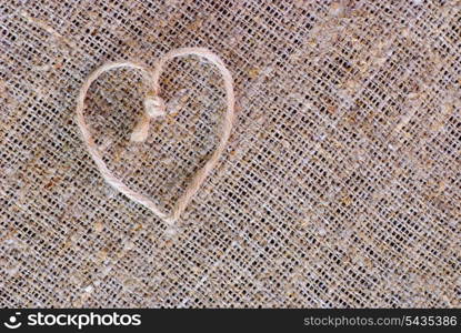 Texture of sackcloth close up and heart shape from rope. Antiquity environment