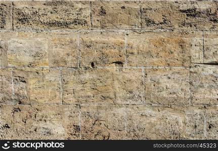 Texture of smooth brown coquina blocks wall