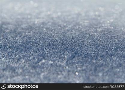 Texture of surface covered with hoar-frost in winter. Background with frozen surface covered by hoar-frost. Extreme natural phenomen hoar-frost on surface. Blue winter texture. Texture of surface covered with hoar-frost in winter. Background with hoar-frost