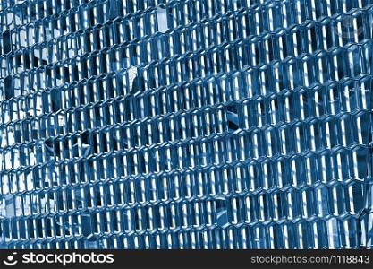 Texture of the building glass facade surface. Color of the year 2020 classic blue toned