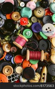 Texture of the buttons. Set of various sewing buttons and thread.Top view