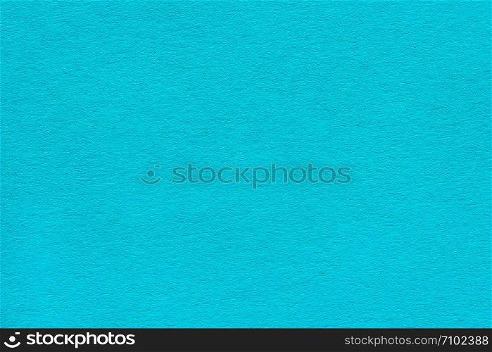 texture of the dense paper is blue-turquoise color. Background for the designer.