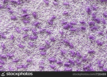 Texture of the knitted fabric. Knitting from yarn, handmade. A pattern of color white and purple yarn, background.. Texture of the knitted fabric. Knitting from yarn, handmade. A pattern of color white and purple yarn, background