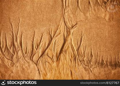 Texture of wet sea sand with patterns of water