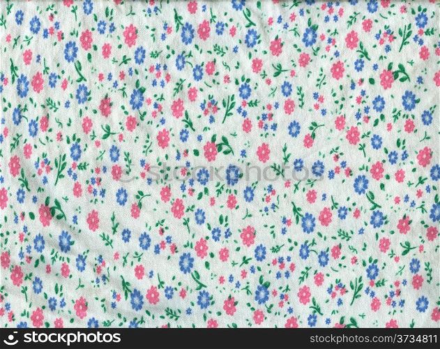 Texture of white knitted fabric in small pink and blue flowers