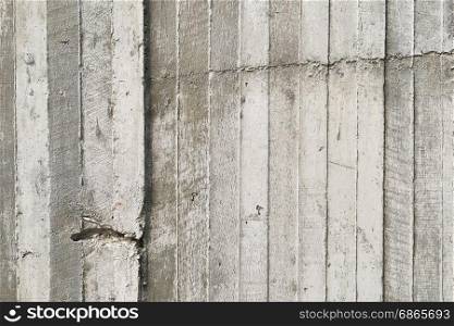 texture of wooden formwork stamped on a raw concrete wall as background