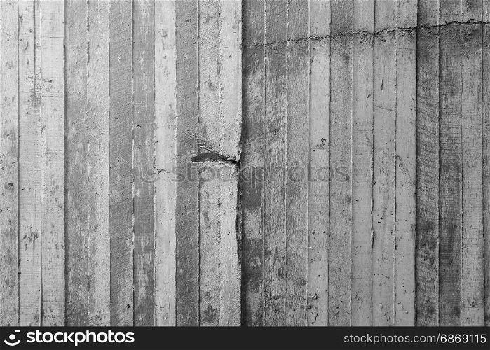 texture of wooden formwork stamped on a raw concrete wall as background
