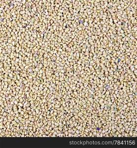 Texture of yellow and pink dry fenugreek seeds