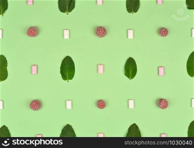 Texture or pattern with ?int leaves, raspberry and gum isolated on mint background. Set of peppermint leaves. Mint Pattern. Flat lay. Top view.