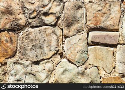 textured background - outdoor wall from natural boulders
