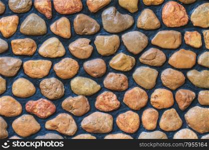 Textured stone wall in gaden at home, Thailand.
