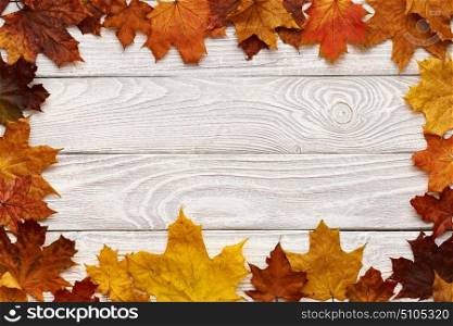 Textured vintage rustic wooden background with autumn yellow leaves