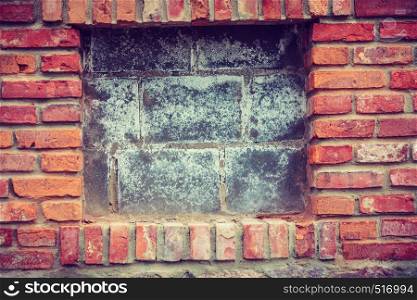Textures and close up detailed patterns concept. Red brick wall with wooden pieces. Red brick wall with wooden pieces