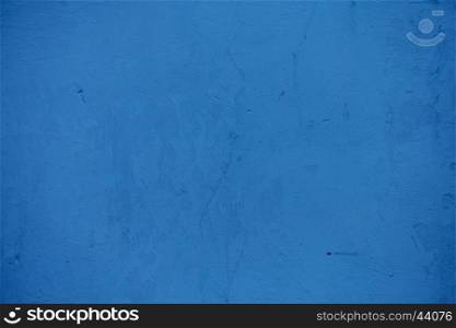 Textures on the blue wall, for background. Grungy blue concrete wall background. Background from high detailed fragment stone wall. Cement texture. Blue concrete wall.
