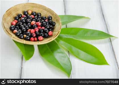 Thai Blueberry fruits. Thai Blueberry in bamboo basket over wooden background , still life