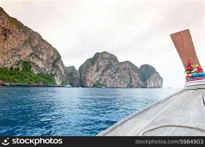 Thai boat sailing in sea. Traditional wooden thai boat in a picture perfect tropical bay