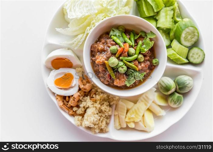 Thai chili paste with fresh vegetables on white background