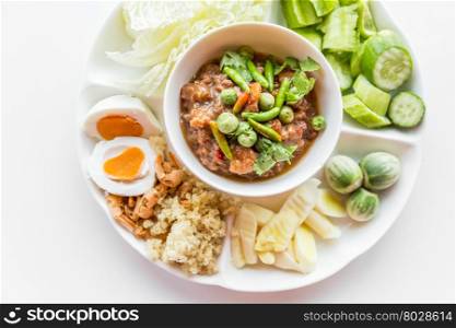 Thai chili paste with fresh vegetables on white background