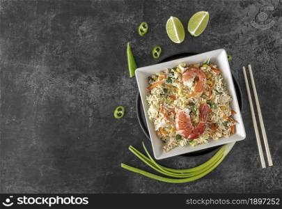 Thai cuisine, stir fried rice with shrimps and vegetables, served with lime and chili