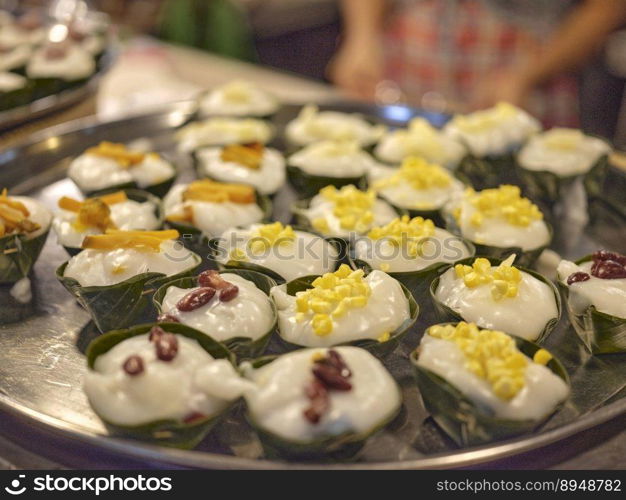 Thai desert ,Famous Thai Pudding with Coconut topping on banana leaf Tako 