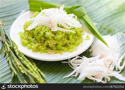 Thai dessert - pounded unripe rice food rice flakes cereal with coconut and sugar, Green rice sweet with ears of rice pandan leaf, Food dessert or snacks - Khao Mao name in Thailand 