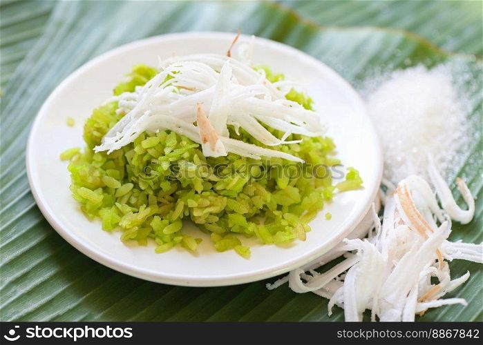 Thai dessert - pounded unripe rice food rice flakes cereal with coconut and sugar, Green rice sweet with ears of rice pandan leaf, Food dessert or snacks 