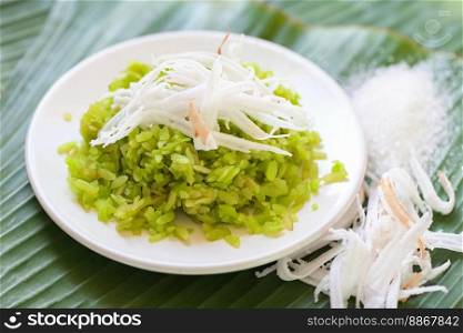 Thai dessert - pounded unripe rice food rice flakes cereal with coconut and sugar, Green rice sweet with ears of rice pandan leaf, Food dessert or snacks 
