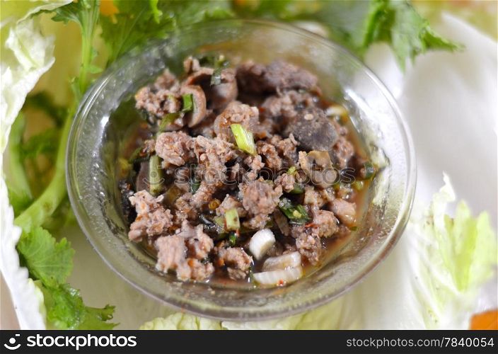 Thai dish of spicy minced pork eaten with vegetable