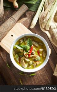 Thai food chicken green curry on wooden background.  