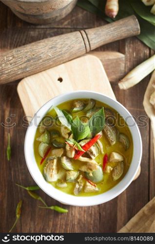 Thai food chicken green curry on wooden background.  