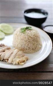 Thai food gourmet steamed chicken with rice khao mun kai in wood background 