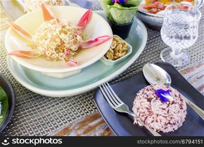 Thai food set menu on outdoor table with orange sun glare