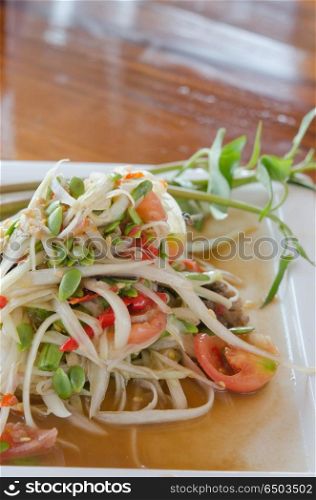 thai food, spicy papaya salad with mixed vegetable on dish
