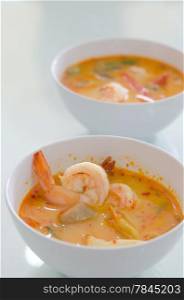Thai hot and spicy seafood soup with shrimp and vegetable in white bowl. Tom Yum Goong