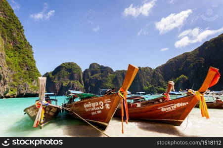 Thai longtail boat in turquoise water at Maya Bay