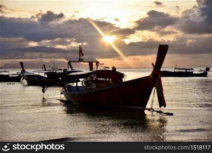 Thai longtail boat in turquoise water in sunset