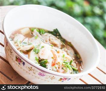 Thai noodles with pork and shrimp in spicy soup