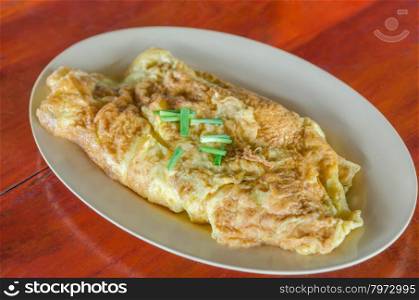 Thai omelette . Thai omelette or scrambled eggs with spring onion on dish