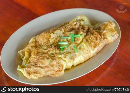 Thai omelette . Thai omelette or scrambled eggs with spring onion on dish