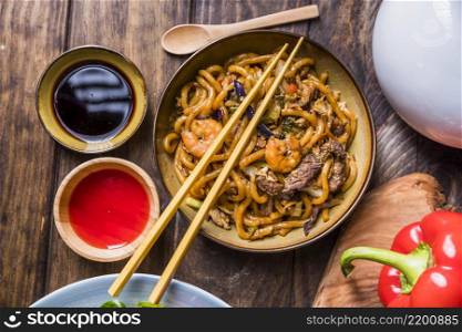thai pad with vegetable king prawns beef with soya sauce wooden table