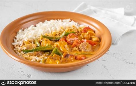 Thai red chicken curry with tomatoes close up