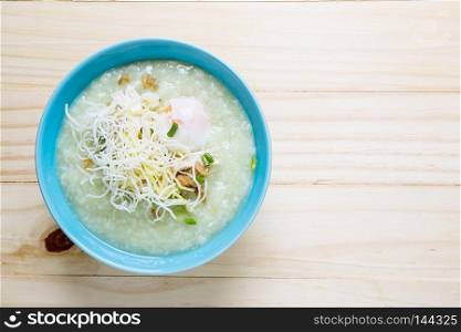 Thai rice porridge with pork on wood table,pork congee