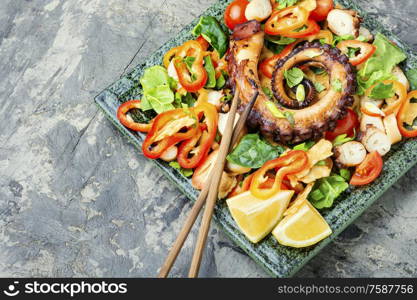 Thai salad with grilled octopus and fresh vegetables.. Healthy octopus salad