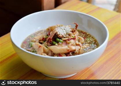 Thai spicy food , santol salad with steamed crab in white bowl