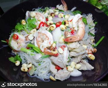 Thai spicy glass noodle salad with a shrimp and pork on the plate